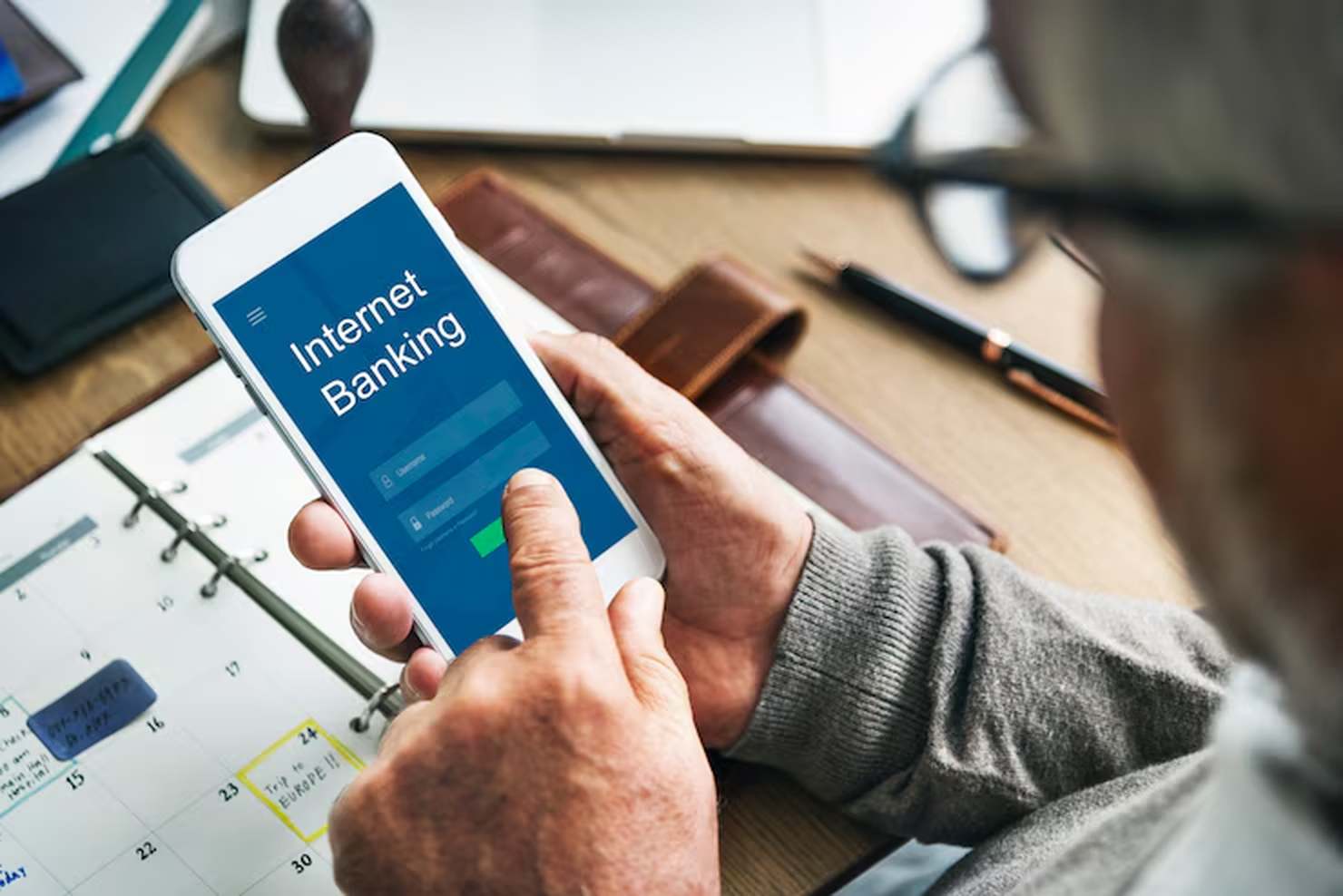 A person accessing a digital banking app on a smartphone, representing how digital banking empowers immigrants and minority communities with easier access to financial services and greater autonomy in money management.